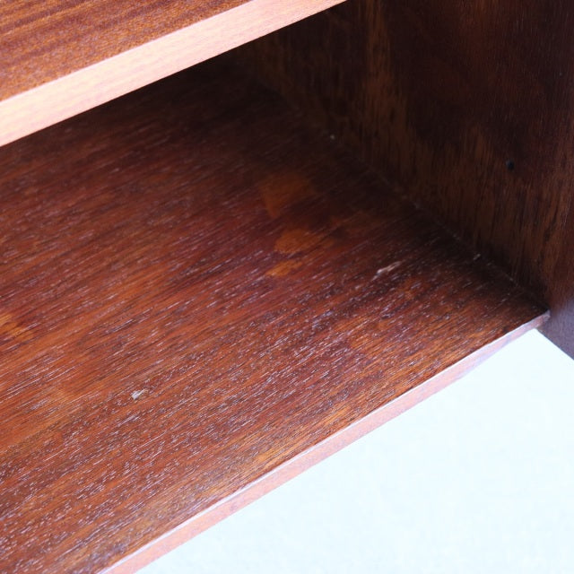 Close-up of vintage teak wood grain and smooth finish inside a mid-century British Dalescraft sideboard shelf.