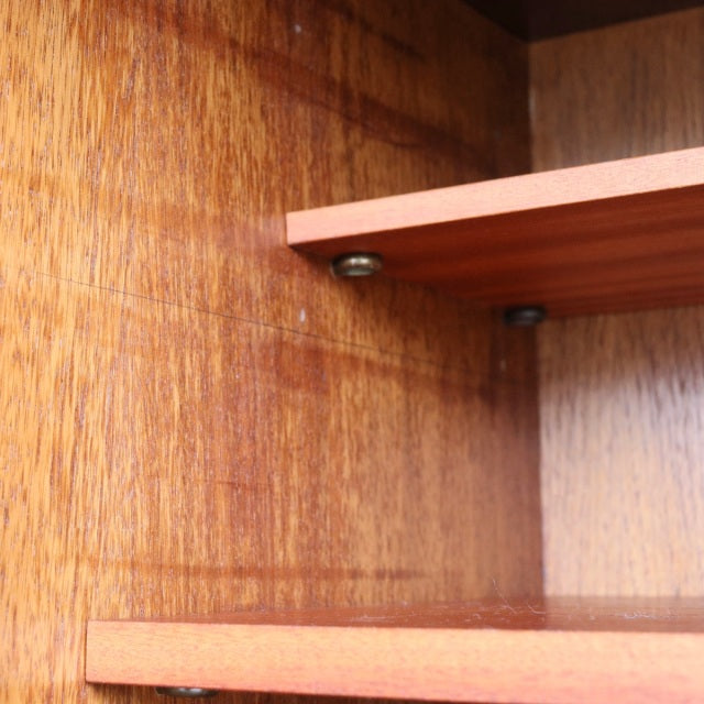 Close-up of mid-century British teak sideboard interior showcasing warm wood grain and smooth shelf edges from Dalescraft.