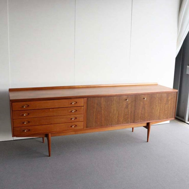 Mid-century British vintage teak sideboard by Robert Heritage for Archie Shine with clean wood grain, four drawers on left,.