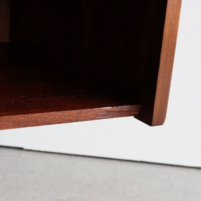 Close-up of vintage teak mid-century British Dalescraft sideboard corner showing rich wood grain and smooth edge detail.