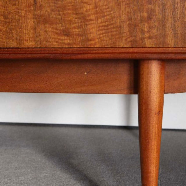 Mid-century British vintage teak sideboard leg with warm wood grain and smooth rounded edge design.