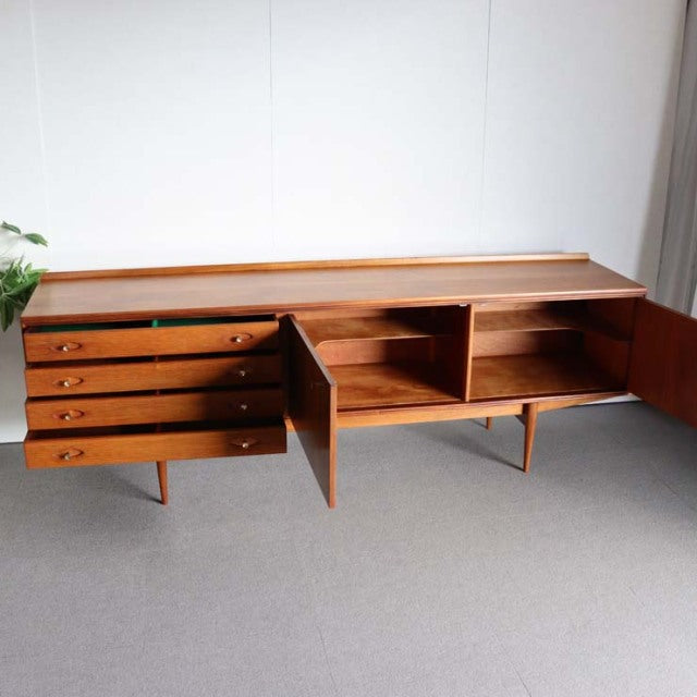 Mid-century British vintage teak sideboard by Robert Heritage for Archie Shine, featuring rich wood grain, four drawers with .