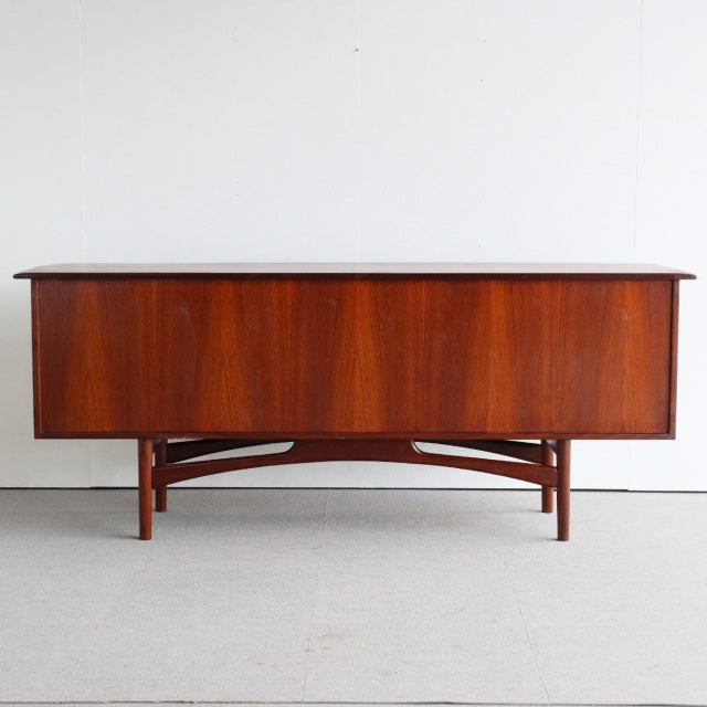 Vintage teak wooden sideboard by Dalescraft with rich wood grain, British mid-century design, and slender angled legs.