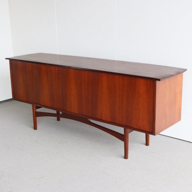 Vintage British mid-century teak sideboard by Dalescraft, rich wood grain, sleek tapered legs, elegant rectangular form.