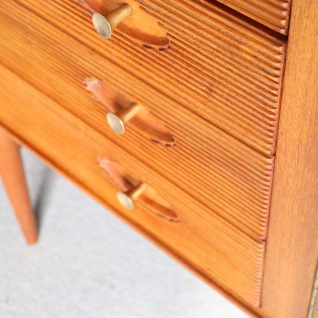 Mid-century British teak sideboard with rich wood grain, tapered legs, and sculpted drawer pulls designed by Robert Heritage .