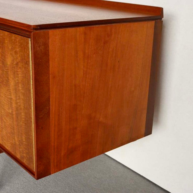 Mid-century British vintage teak sideboard with clean lines, smooth wood grain, and tapered legs by Robert Heritage for.