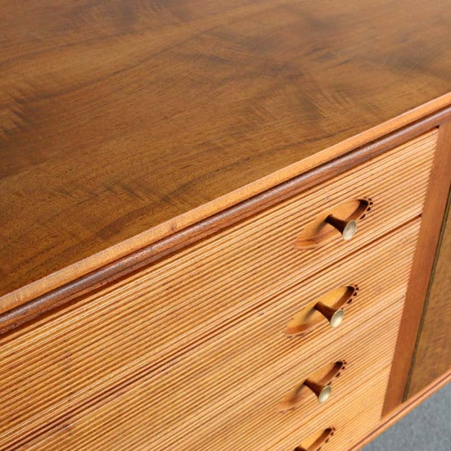Mid-century teak sideboard with rich wood grain, three drawer pulls, and Robert Heritage design details.