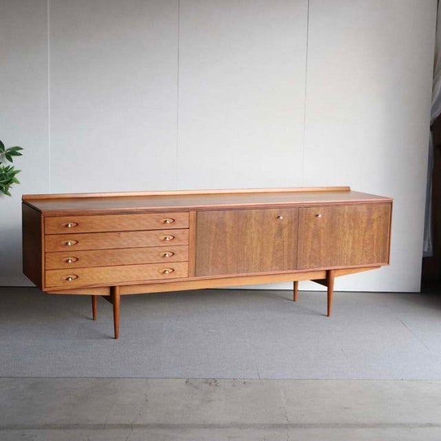 Mid-century British vintage teak sideboard by Robert Heritage for Archie Shine, featuring rich wood grain, four drawers with .