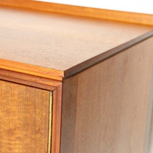 Mid-century British vintage teak sideboard corner with rich wood grain and smooth edges.