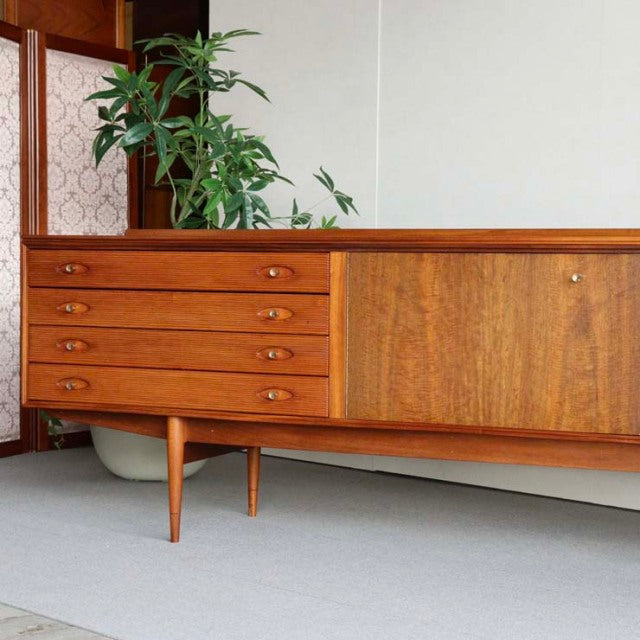 Mid-century British vintage teak sideboard by Robert Heritage with rich wood grain, rounded edges, tapered legs, and five.