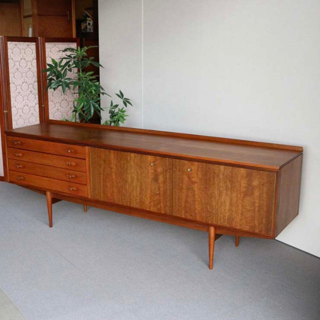 Mid-century British vintage teak sideboard by Robert Heritage for Archie Shine, featuring sleek wood grain, four drawers,.