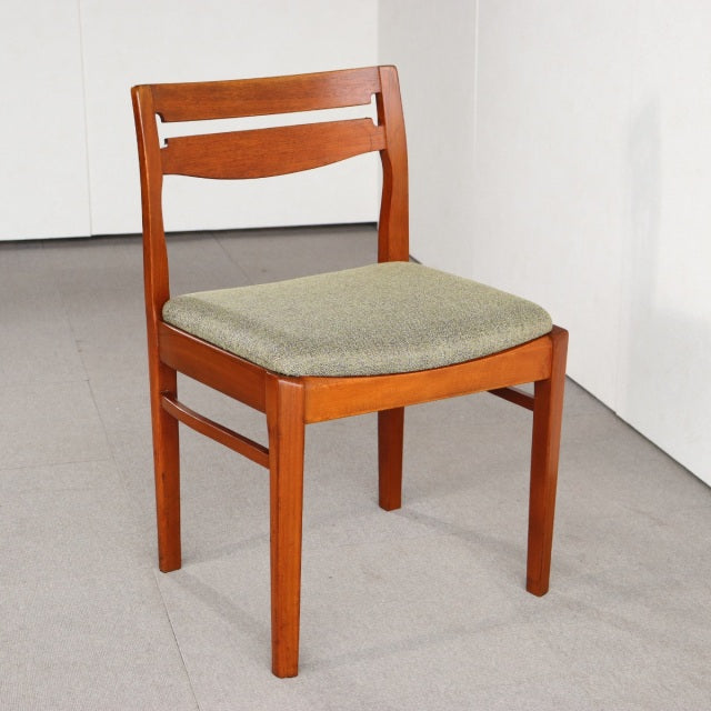 Mid-century vintage teak dining chair by Nathan with green upholstered seat and curved backrest, British design influence.