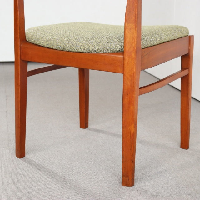 Vintage teak dining chair by Nathan with clean mid-century British design, green upholstered seat, visible wood grain,.