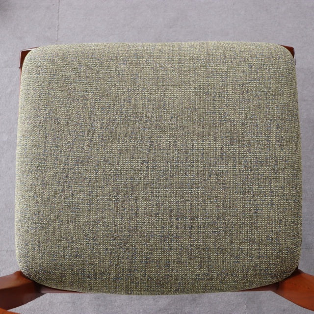 Vintage mid-century British Nathan dining chair with teak frame and textured light green upholstered seat.