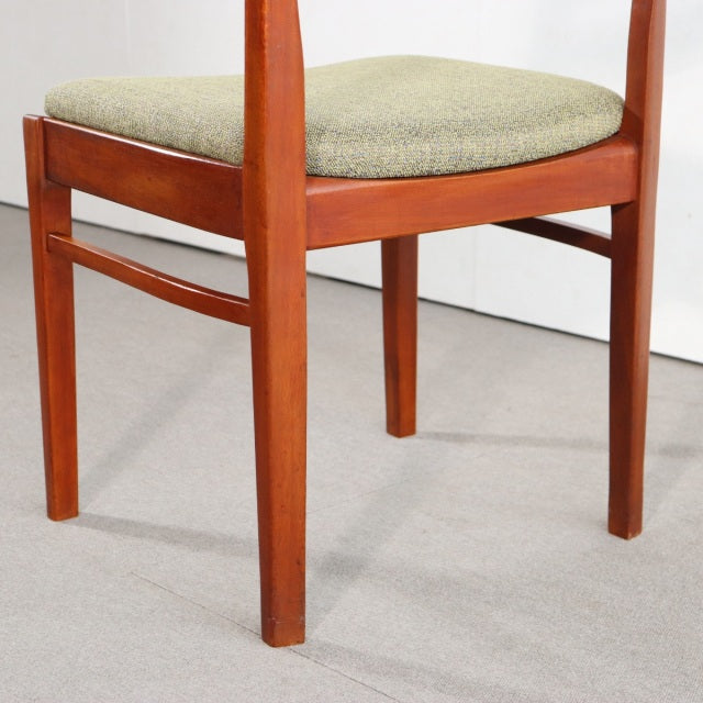 Vintage mid-century teak dining chair by NATHAN featuring clean British design with slender tapered legs and textured beige.
