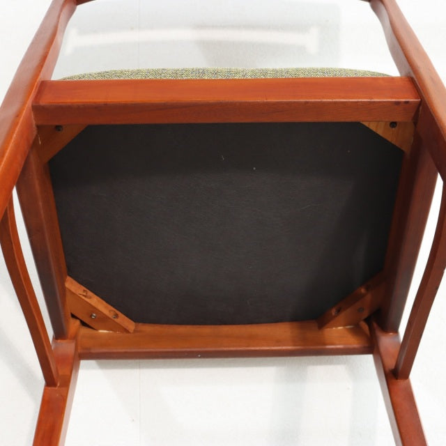 Mid-century vintage teak dining chair from British brand NATHAN, showcasing smooth wooden frame and sturdy angled legs with.