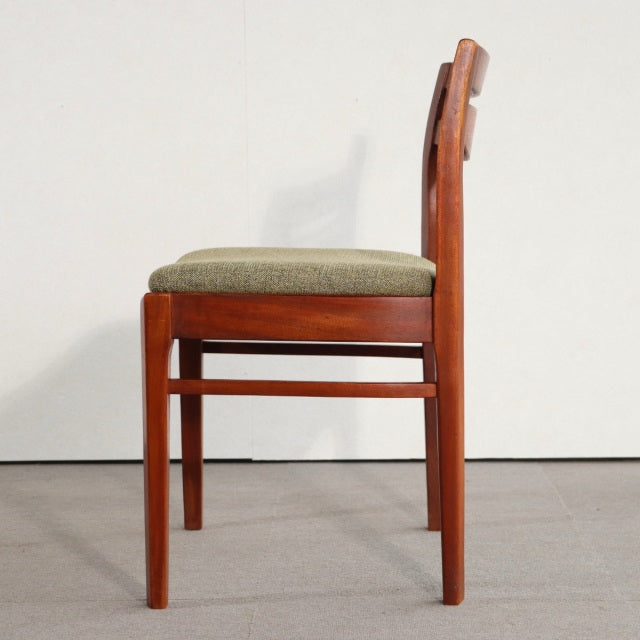 Mid-century British vintage NATHAN teak dining chair with olive fabric seat and sleek wood grain legs.