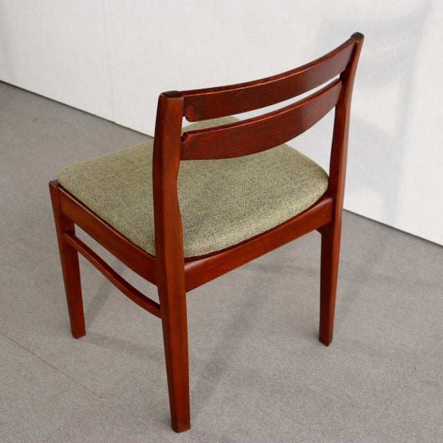Vintage teak dining chair by Nathan with mid-century British design, curved slat back and green upholstered seat.