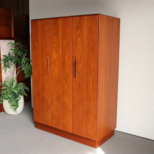 Vintage British mid-century teak wardrobe by G-Plan with clean lines, vertical wood grain, and recessed handles.