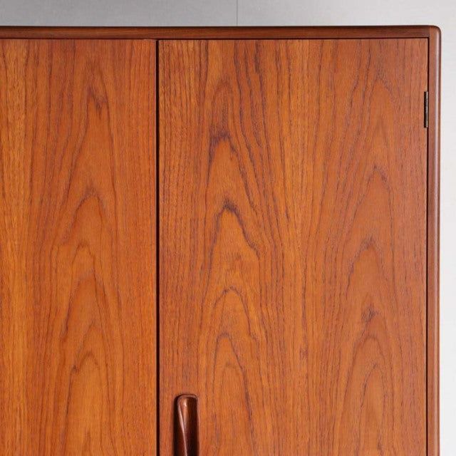 Vintage teak G-plan wardrobe door panel showcasing rich wood grain and smooth mid-century British craftsmanship.