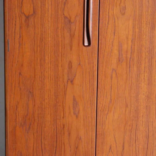 Vintage British mid-century G-Plan teak wardrobe door panel with smooth grain and curved edge handle.