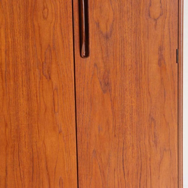 Mid-century British G-Plan teak wardrobe with smooth wood grain and recessed vertical handle detail.