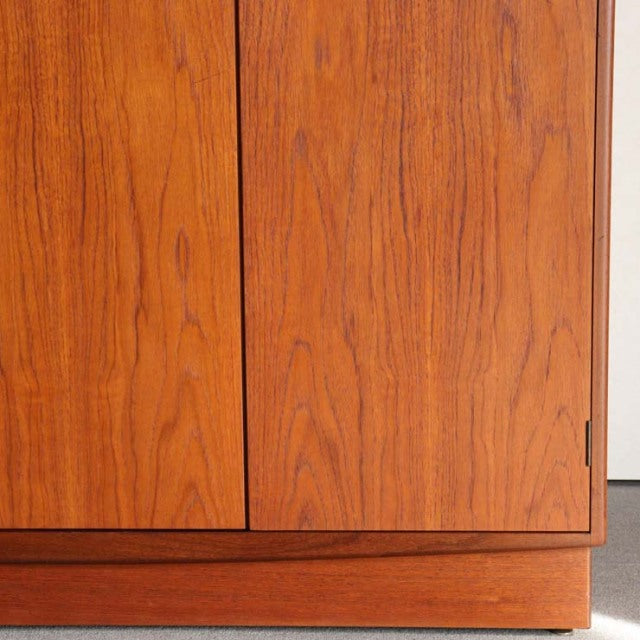 Vintage teak G-Plan wardrobe with mid-century British design, smooth wood grain and clean lines.