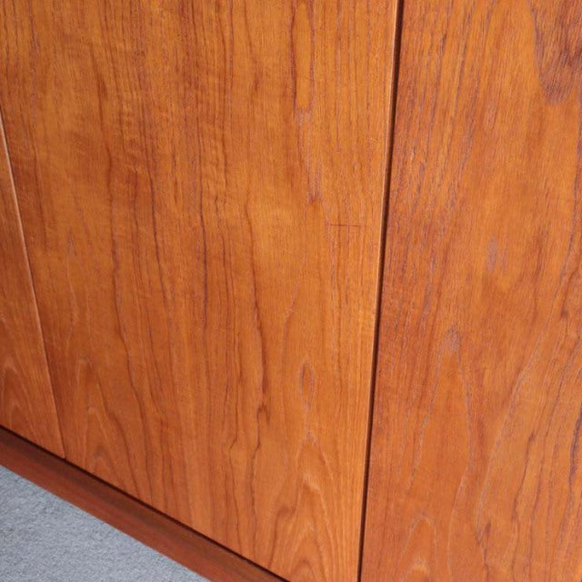 Close-up of vintage British mid-century G-Plan teak wardrobe door panels showing smooth wood grain and warm honey tones.