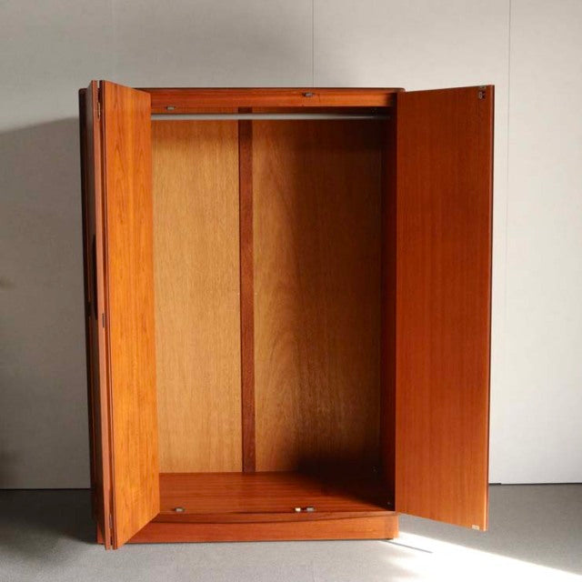 Vintage mid-century British G-Plan teak wardrobe with open double doors, showcasing wood grain and simple clean lines.