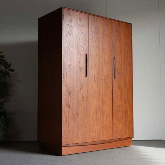 Vintage British mid-century teak wardrobe by G-Plan with rich wood grain, tall slender handles, and clean-lined rectangular.