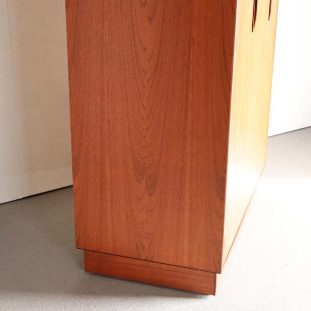 Vintage British mid-century teak G-Plan wardrobe corner showing smooth wood grain and stepped base detail from Denmark.