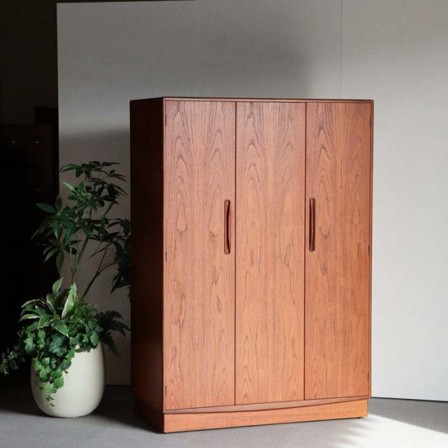 Vintage teak G-Plan wardrobe with rich wood grain, British mid-century design, clean lines, and recessed handles.