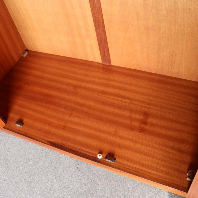 Interior view of vintage British mid-century teak G-Plan wardrobe showing smooth wood grain and clean lines.