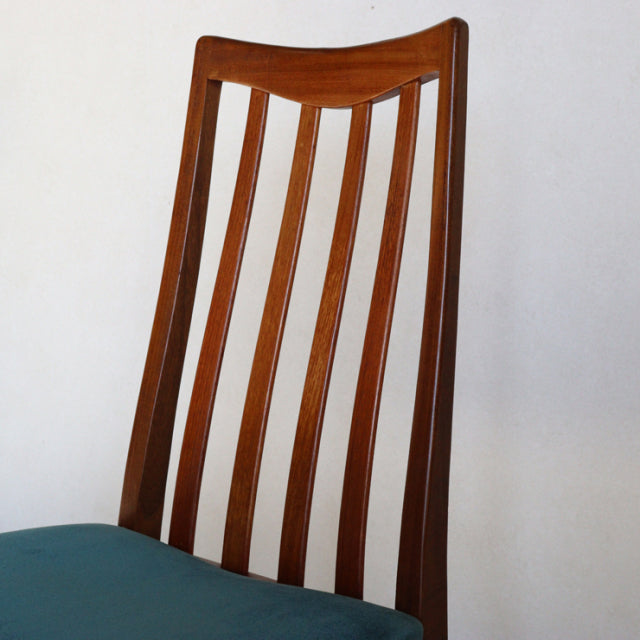 Vintage G-Plan mid-century teak dining chair with elegant vertical slat back and angled legs in natural wood finish with.