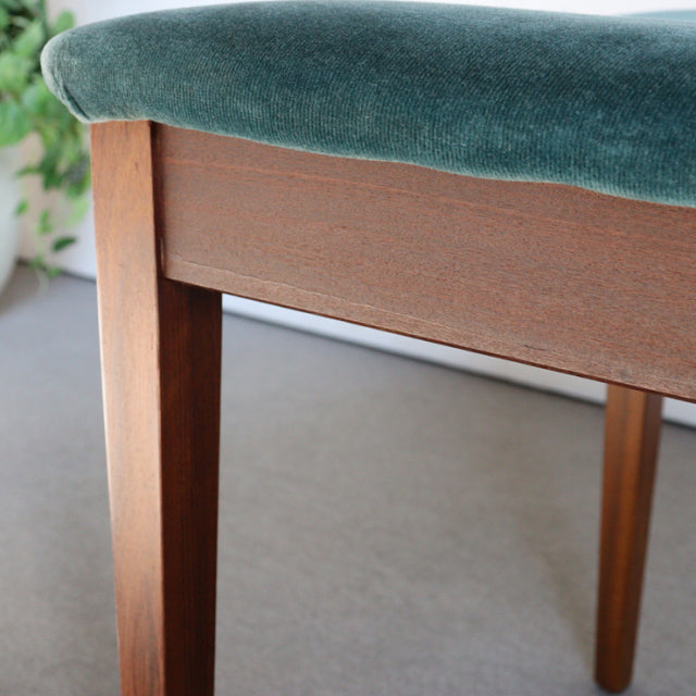 Mid-century British G-PLAN dining chair with teak wood frame and teal green upholstered seat showing smooth wood grain and.