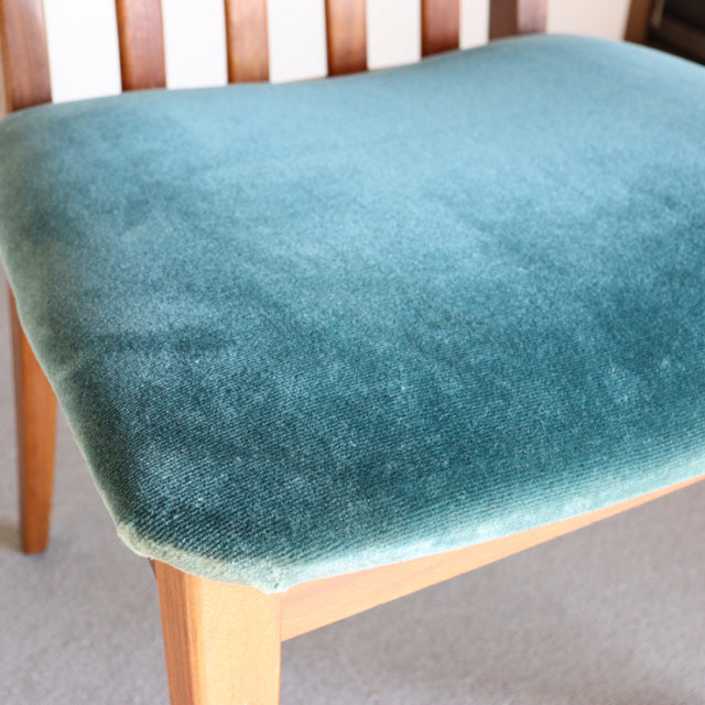 Vintage British mid-century G-Plan dining chair with teal green velvet seat, teak wood frame, and tapered legs.