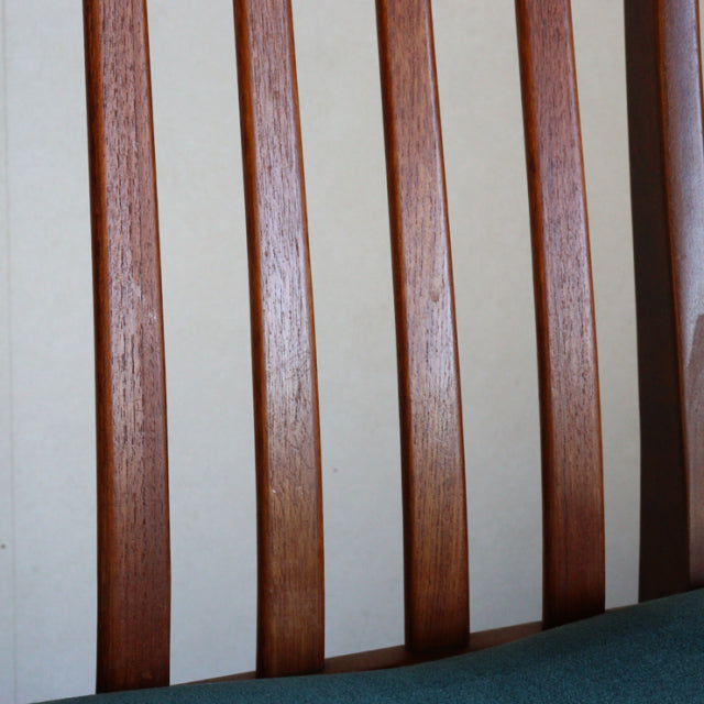 Mid-century British G-Plan vintage teak dining chair backrest with vertical slats and visible wood grain.