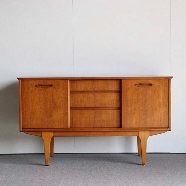 Vintage teak Jentique British mid-century sideboard with three central drawers and two side cabinets on tapered legs, Danish .