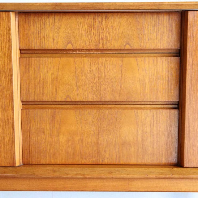 Compact mid-century Jentique teak sideboard with rich wood grain and clean British vintage design.