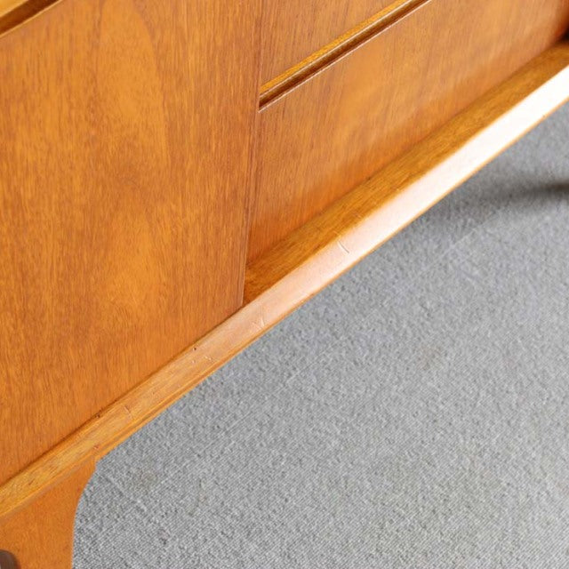 Mid-century vintage British teak sideboard by Jentique with smooth wood grain and tapered legs.