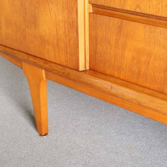 Mid-century British vintage teak sideboard corner showing warm wood grain and tapered angled leg by Jentique.