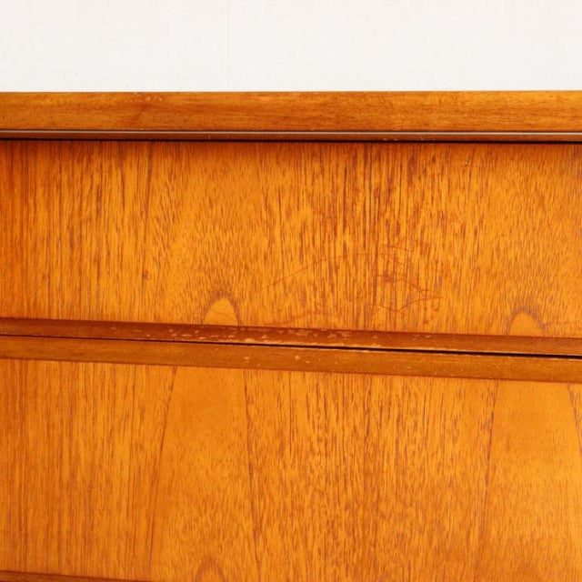 Close-up of vintage Jentique British teak sideboard showing rich wood grain and mid-century Danish design details.