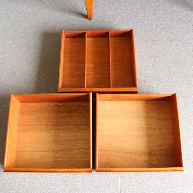 Set of three teak drawers from a vintage British mid-century Jentique sideboard, showcasing fine wood grain and clean lines.