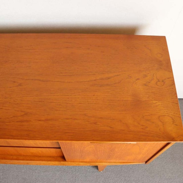 Mid-century British Jentique teak sideboard top showing warm wood grain and smooth finish.