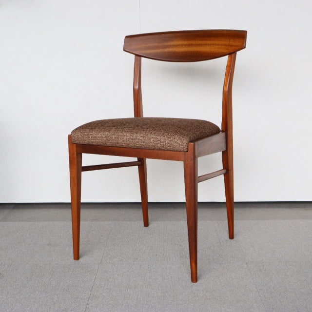 Mid-century British vintage teak dining chair by McIntosh with curved backrest and textured brown fabric seat.