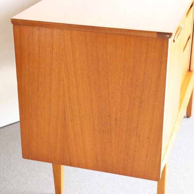 Compact vintage teak sideboard by Jentique, British mid-century design with clean lines and tapered legs.