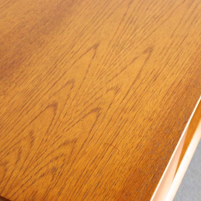 Close-up of British vintage Jentique teak sideboard top showcasing warm mid-century wood grain and smooth finish.
