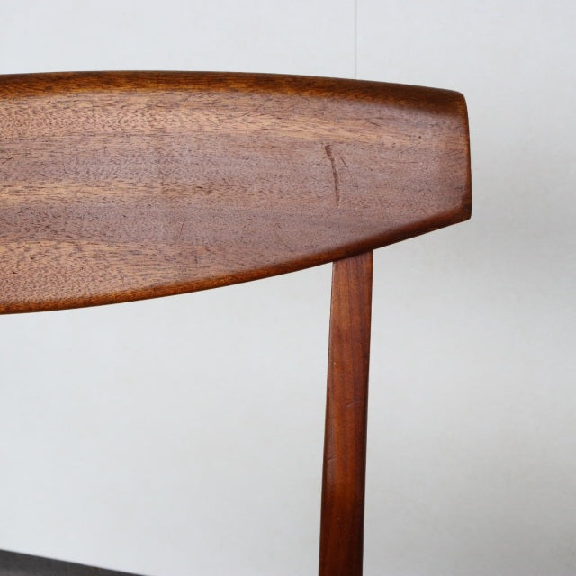 Mid-century British McIntosh dining chair backrest in vintage teak with rich wood grain and smooth rounded edges.