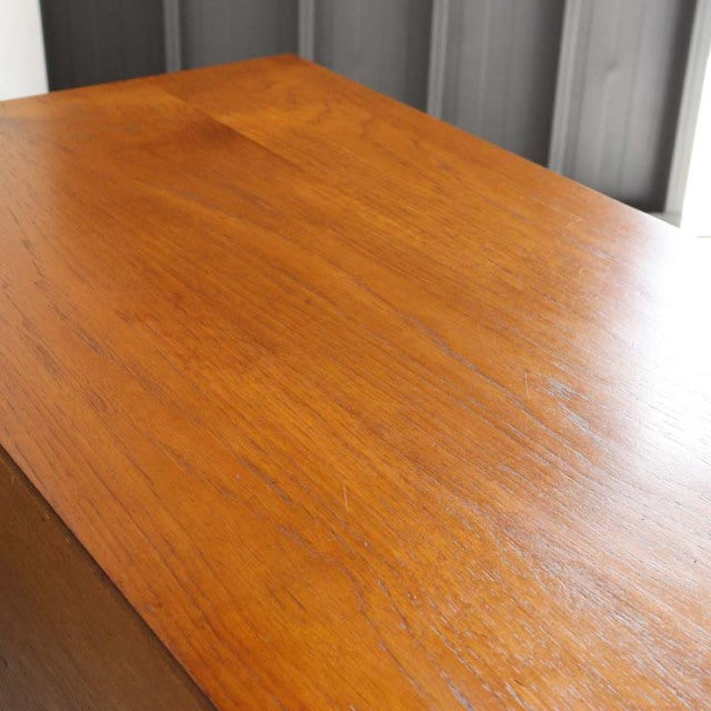 Mid-century British vintage teak sideboard top showing warm wood grain and smooth finish.