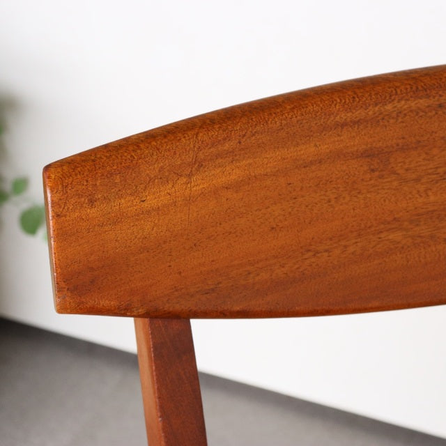 Mid-century vintage teak dining chair backrest with smooth wood grain, British McIntosh design.